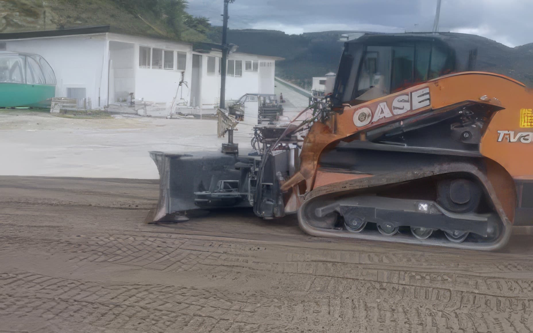 Mezzo cingolato al lavoro sulla sabbia in preparazione del campo